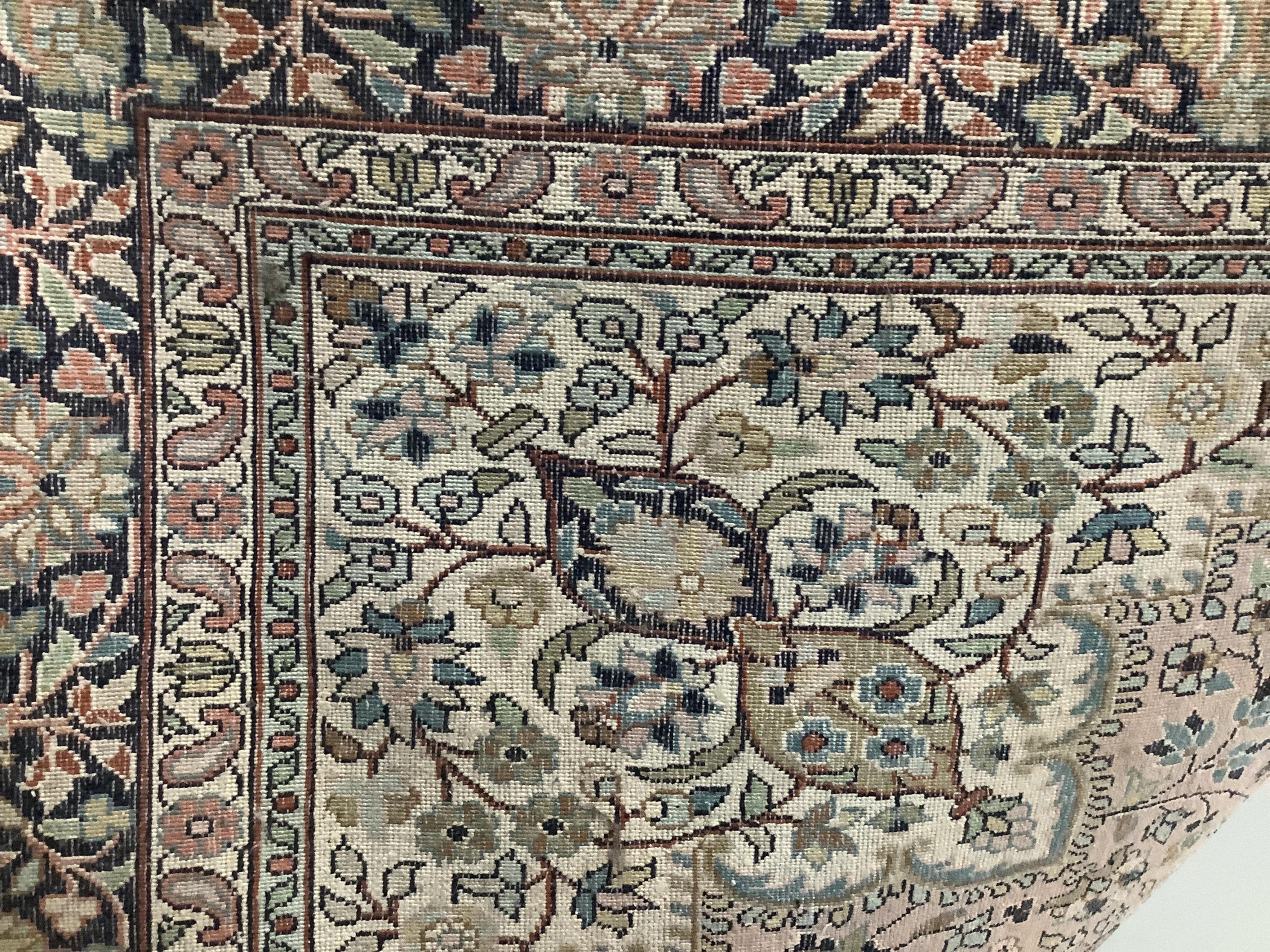 An Indian ivory ground rug, 190 x 121cm. Condition - poor